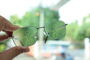 Hand holding eyeglass, eyeglasses in hand, hand holding glasses in optical store photo