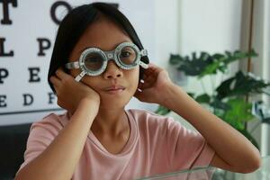 Eye care, Child wearing glasses in the optical store, kid eye test, children eye check, eye exam, child eye test, photo