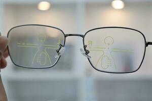 Hand holding eyeglass, eyeglasses in hand, hand holding glasses in optical store photo