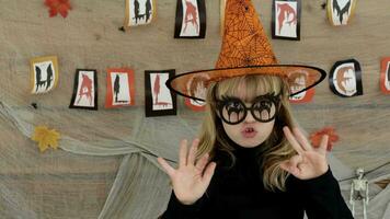 uma pequeno menina vestindo uma bruxa chapéu e óculos video