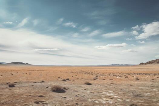 A landscape photograph featuring a vast expanse of empty space, such as a desert field. photo