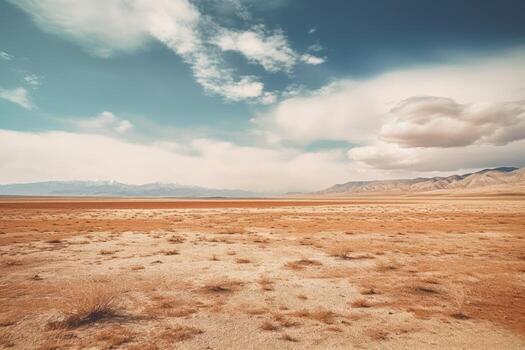 A landscape photograph featuring a vast expanse of empty space, such as a desert field. photo