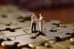 Close-up shot of two elegantly dressed miniature figures standing on puzzle pieces. photo