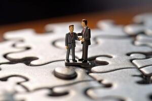 Close-up shot of two elegantly dressed miniature figures standing on puzzle pieces. photo