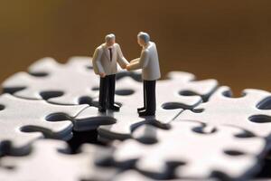 Close-up shot of two elegantly dressed miniature figures standing on puzzle pieces. photo