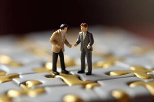 Close-up shot of two elegantly dressed miniature figures standing on puzzle pieces. photo