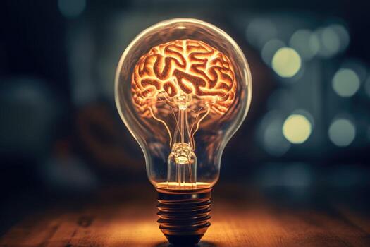 Close - up photo showcases the concept of a creative idea through the visual representation of a brain and a light bulb.