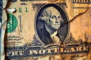 A close - up photograph symbolizing the global financial crisis. The image focuses on a stack of crumpled dollar bills, symbolizing the devaluation of currency. photo