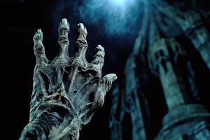 A close - up photography showcasing a zombie hand rising from a graveyard on a spooky Halloween night. photo