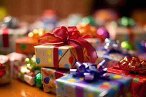 A pile of wrapped gift boxes, their colorful paper and bows. photo