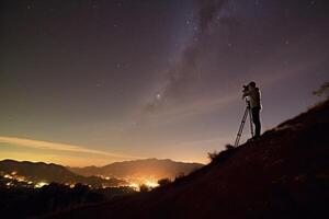 A stargazer perches on a hill, his telescope pointed towards the night sky's celestial bodies. Generative AI photo