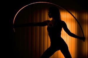 The woman dancing with gymnastic rings. Generative AI photo