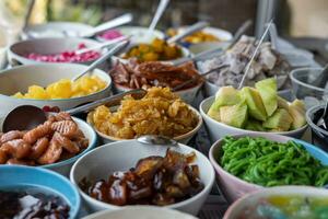 Close-up view of slices of pineapple and lotus root in glazed syrup and a variety. photo