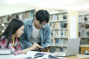 Young students campus helps friend catching up and learning. photo