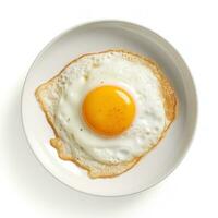 Fried egg on white plate isolated photo