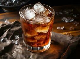 An ice cola in a glass on a sack table photo