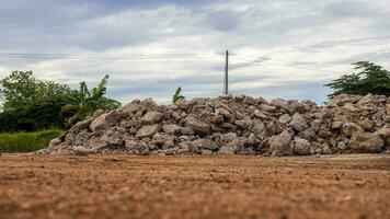 Low angle view of the demolished concrete road rubble piled on the ground. photo