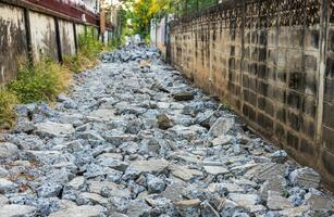 A background view of a smashed concrete road lined with rubble. photo