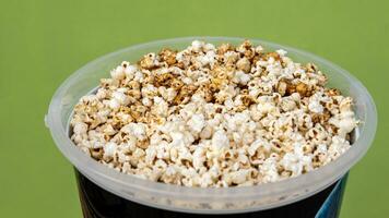 A close-up view of the background from the side, lots of popcorn, a popular crunchy food. photo