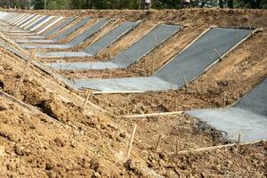 View of the concrete wall construction structure which is attached to the soil. photo