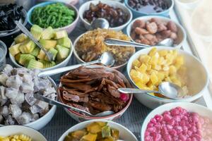 Close-up view of slices of pineapple and lotus root in glazed syrup and a variety. photo