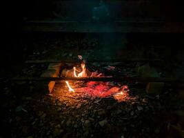 Burning wood at night Flame and fire burning on a black background photo