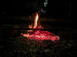 Burning wood at night Flame and fire burning on a black background photo