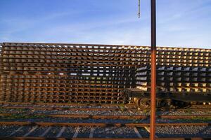 Railway Concrete sleepers stacked under the blue sky for the construction of a new track in Bangladesh photo