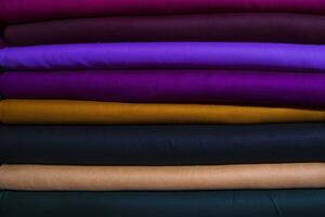 Artistic variety shade tone colors Textile Fabrics stacked on retail Shop Shelf to sale photo