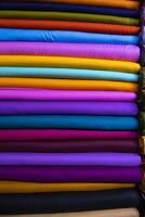 Artistic variety shade tone colors Textile Fabrics stacked on retail Shop Shelf to sale photo