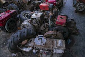 scrapped old power tiller engine on junkyard photo