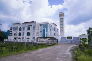 Most Beautiful architecture Model Mosque in Bangladesh with a White cloudy Blue sky photo