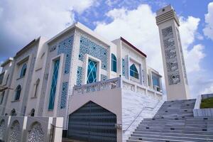 Most Beautiful architecture Model Mosque in Bangladesh with a White cloudy Blue sky photo