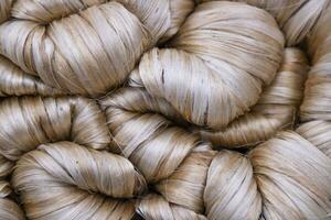 Thick Golden bundle of raw jute fiber Pattern Texture Can be used as a Background wallpaper photo