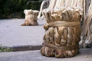 A thick brown  bundle of raw jute has on the ground photo