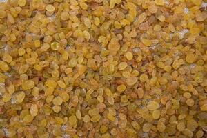 Dried fruits Yellow sweet delicious raisins pattern texture can be used as a background wallpaper photo