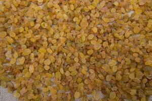 Dried fruits Yellow sweet delicious raisins pattern texture can be used as a background wallpaper photo