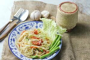 Somtum, Thai spicy papaya salad on white background photo