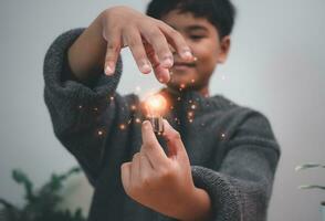 The boy is holding a light bulb. It represents the concept of education, learning, innovation, and success. photo