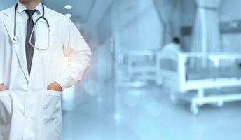 Doctor in lab coat with arms crossed against light green background photo