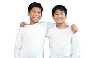 Brothers wearing white long-sleeved T-shirts smile and show joy together. photo