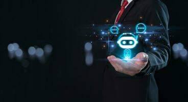 Businessman holding hologram digital chatbot, robot application, conversation assistant, AI Artificial Intelligence concept, digital chatbot on virtual screen.Technology concept. photo
