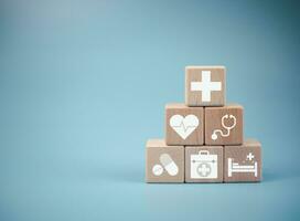 Wooden cube blocks stacked with icons. Health and Medicine Concepts. photo