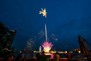 fireworks on the river in the dark sky photo