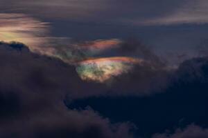 Iridescent Cloud or irisation is a colorful optical phenomenon that occurs in a cloud. photo