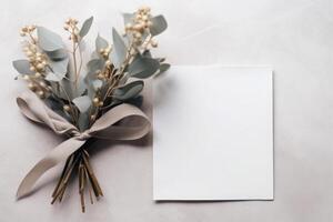 Blank greeting paper card, invitation mockup scene top view with eucalyptus tree branches. Elegant stationery on white table background. photo