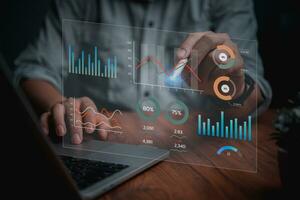 Man programmer using laptop analyzing marketing and development information and Data Management System virtual interface screen.Business Intelligence data analysis, management concept. photo
