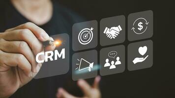 Businessman touching CRM Customer Relationship Management on virtual screen. Community Marketing, Business development concept. photo