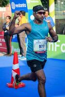 New Delhi, India - July 16 2023 - Vedanta Delhi Half Marathon race after covid in which marathon participants about to cross the finish line, Delhi Half Marathon 2022 photo