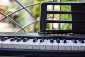 Close-up of piano keys. Piano black and white keys and Piano keyboard musical instrument placed at the home balcony during sunny day. photo